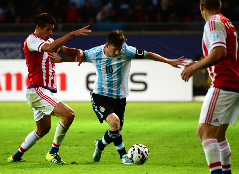 Argentina's forward Lionel Messi and Paraguay's midfielder Victor Caceres vie for the ball during their 2015 Copa America football championship match, in La Serena, on June 13, 2015. AFP PHOTO / MARTIN BERNETTI
