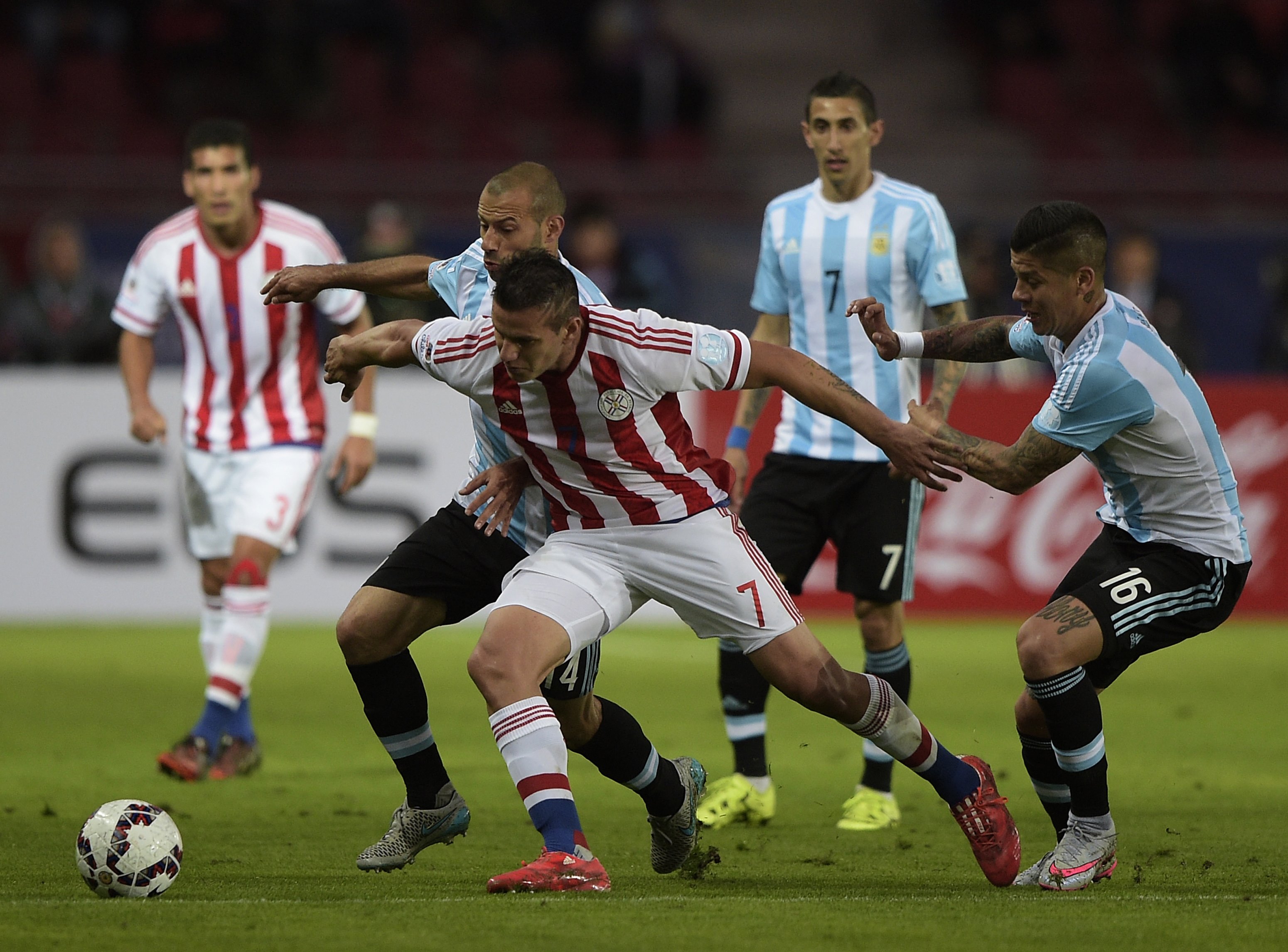 Paraguay's forward Raul Bobadilla and Argentina's midfielder Javier Mascherano vie for the ball during their 2015 Copa America football championship match, in La Serena, on June 13, 2015. AFP PHOTO / JUAN MABROMATA