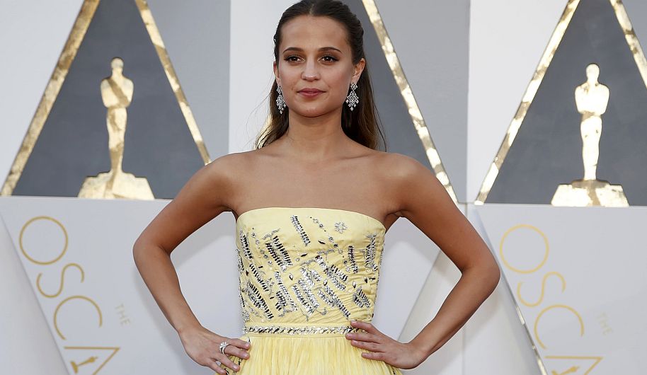 Alicia Vikander, nominated for Best Supporting Actress in "Danish Girl," wears a yellow Louis Vuitton gown as she arrives at the 88th Academy Awards in Hollywood, California February 28, 2016.  REUTERS/Lucy Nicholson