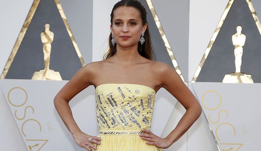 Alicia Vikander, nominated for Best Supporting Actress in "Danish Girl," wears a yellow Louis Vuitton gown as she arrives at the 88th Academy Awards in Hollywood, California February 28, 2016. REUTERS/Lucy Nicholson