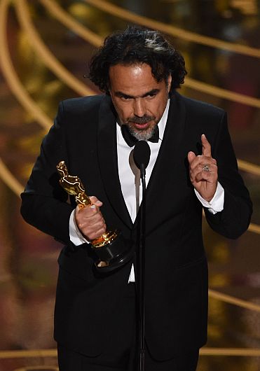 Director Alejandro Gonzalez Inarritu accepts his award for Best Director in The Revenant on stage at the 88th Oscars on February 28, 2016 in Hollywood, California. AFP PHOTO / MARK RALSTON