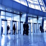 Entrance to modern building and people silhouettes
