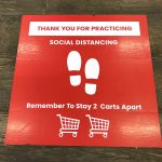 Social Distancing sign on the floor of grocery store