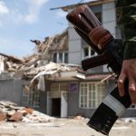 Un militar de la Milicia Popular LPR es visto por un edificio dañado por un bombardeo en la ciudad de Kreminna, Ukania. Foto Alejandro Reka (TASS)