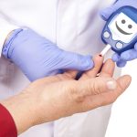 Doctor making blood sugar test. Smiley face